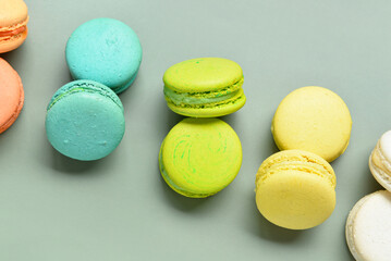 Sweet macaroons on green background