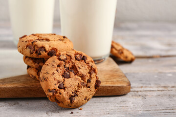 Tasty cookies with chocolate chips on table