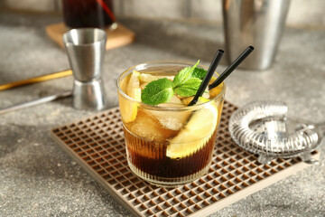 Glass of cold Long Island iced tea on table