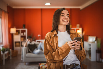 young beautiful woman use mobile phone for fun at home