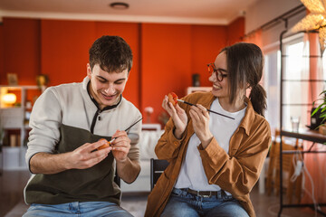 happy couple enjoy while paint decorative easter egg in living room