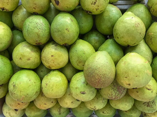Close-up of fresh white guavas, highlighting their natural texture and greenish tones. Ideal for food campaigns, tropical products, and health and wellness content.