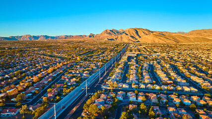 Aerial of Las Vegas Suburb at Golden Hour with Mountain Backdrop