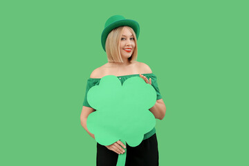 Happy woman with paper clover on green background. St. Patrick's Day