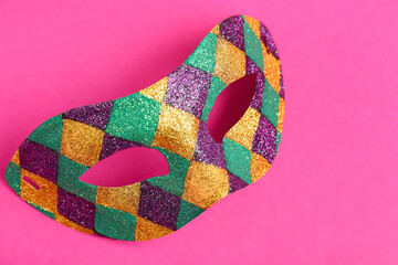 Shiny carnival mask for Mardi Gras celebration on pink background © Pixel-Shot