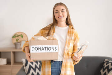 Young woman with food for poor people at home