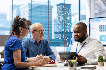 Senior people in a consultation with a financial expert to discuss about retirement plans, covering...