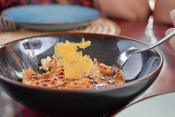 Close up view of beautifully plated milk rice dessert in restaurant