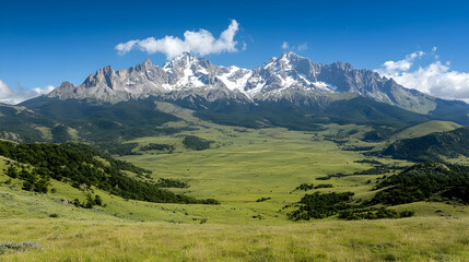 Fototapeta premium Majestic snow-capped mountains overlooking a vast green valley