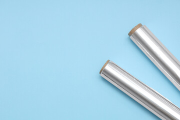 Aluminium foil rolls on blue background