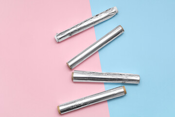 Aluminium foil rolls on color background