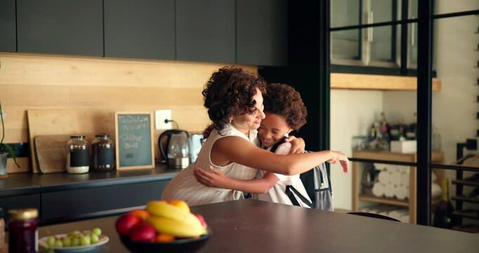 Hug, mother and help child with backpack in kitchen for education support, back to school and morning routine. African family, woman and greeting boy in home for bonding and getting ready to leave