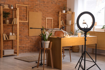 Interior of blogger's office with workplace and shelf units