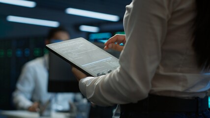 Engineer working in data center used for managing infrastructure rigs energy consumption. Employee...