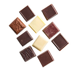 Fototapeta premium Elegant assortment of artisan chocolate squares with diverse textures and flavors arranged on a contrasting black backdrop for a luxurious confectionery visual