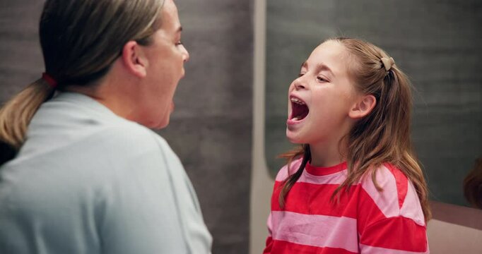 Teeth, mother and check mouth of kid for dental care, learning oral health and clean brushing. Forehead kiss, woman and daughter in bathroom with inspection for gum disease, healthcare and bonding