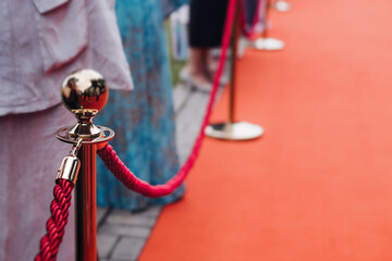 Red carpet with ropes and golden barriers on a luxury party entrance, cinema premiere tv film...