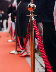Red carpet with ropes and golden barriers on a luxury party entrance, cinema premiere tv film...