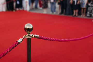 Red carpet with ropes and golden barriers on a luxury party entrance, cinema premiere tv film...