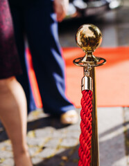 Red carpet with ropes and golden barriers on a luxury party entrance, cinema premiere tv film...