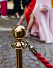 Red carpet with ropes and golden barriers on a luxury party entrance, cinema premiere tv film...