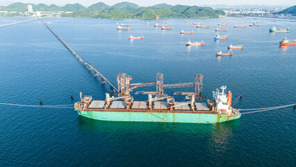 Aerial top view wood chips load chip from silo to cargo ship vessel concept green fuel for save...