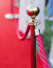 Red carpet with ropes and golden barriers on a luxury party entrance, cinema premiere tv film...