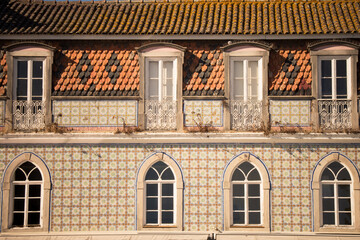 Ornate windows and tiled facade of a traditional building in Sintra, Portugal.