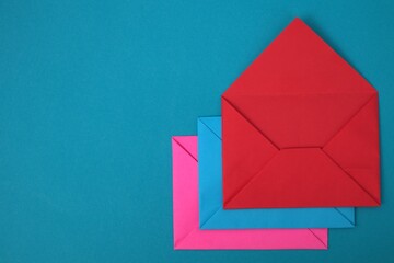 Stack of red, blue and pink envelopes on blue background
