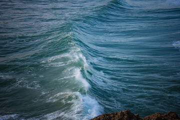 Close-up of a high ocean wave about to break with clear water texture.