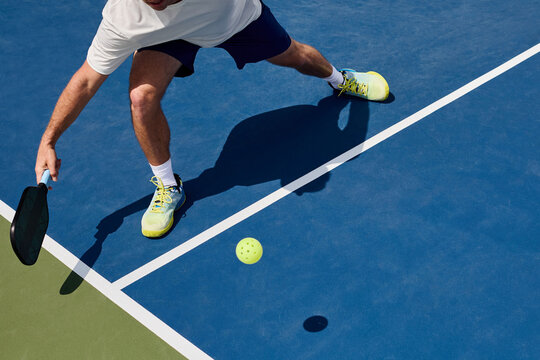 A boy plays a forehand during a pickleball game
