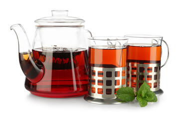 Glasses of aromatic tea in holders, teapot and mint isolated on white