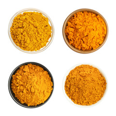 Turmeric powder in bowls isolated on white, set. Top view