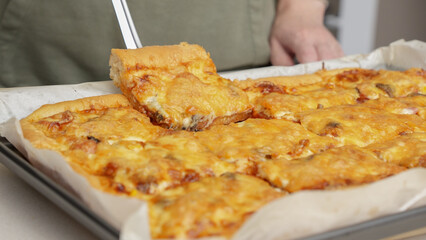 Homemade square pizza with cheese and sausage topping served on wooden table Square pizza, full cheese spread organic pizza healthy pizza