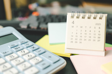 Desk calendar for APRIL 2025 with Sticky note. Calendar concept with 2025 APR calendar. calculator...