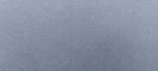 close up textured fabric surface as background, light blue color and features a woven pattern with small, creating a grid like texture, textile design, material quality, and manufacturing processes