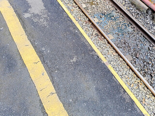 Fototapeta premium Urban Street Scene With Railroad Tracks And Yellow Markings