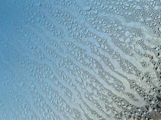 Water Droplets On A Frosty Window Surface