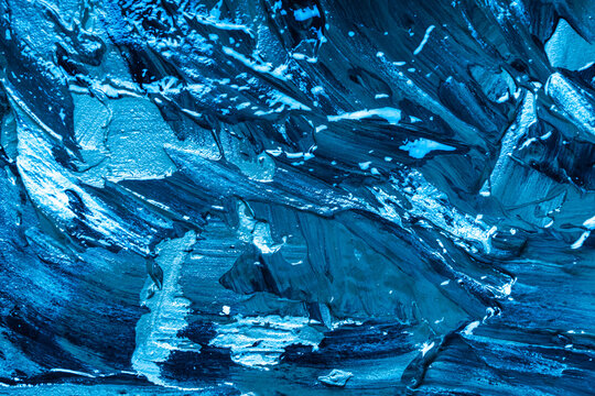 Abstract background with the texture of plaster or oil paint in rich blue color. Seamless background with large brush strokes. Rough stylized texture with space for text. High quality photo