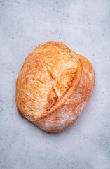 Homemade whole grain freshly baked wheat bread from sourdough. Gray background, top view