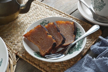 Caramelized Brown Sugar Cassava Cake on a Plate. Malay called Kuih Bingka Ubi