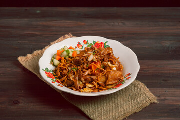 Mie Jawa or Bakmie Jawa, Javanese traditional noodle. Served on plate, Close up. Perfect for recipe, article, catalogue, or any commercial purposes. with copy space.