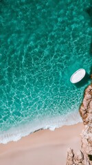 Obraz premium Aerial view of rocky coastline with crashing ocean waves and soft beach sand