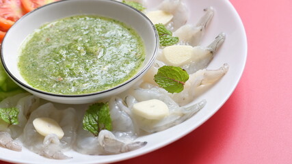 shrimp in fish sauce with Thai spicy seafood dipping sauce on white plate