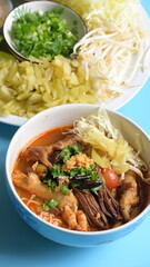 rice vermicelli with northern thai curry sauce on blue background