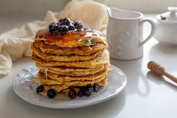 American Blueberry Pancake Stack with Syrup Drizzling Down for Pancake Day/Shrove Tuesday Celebration