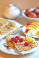 Traditional pancakes with lemon, sugar and raspberries for Shrove Tuesday/Pancake Day celebration