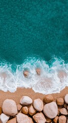Fototapeta premium Close-Up Aerial Shot of Ocean Waves Crashing on Rocks and Sandy Beach with Turquoise Water