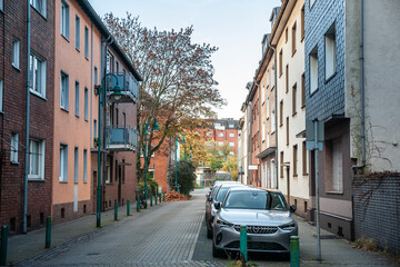 typical german suburban street in Duisburg, Germany, featuring two-story residential buildings and...