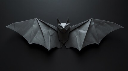 Intricate black origami bat art display.